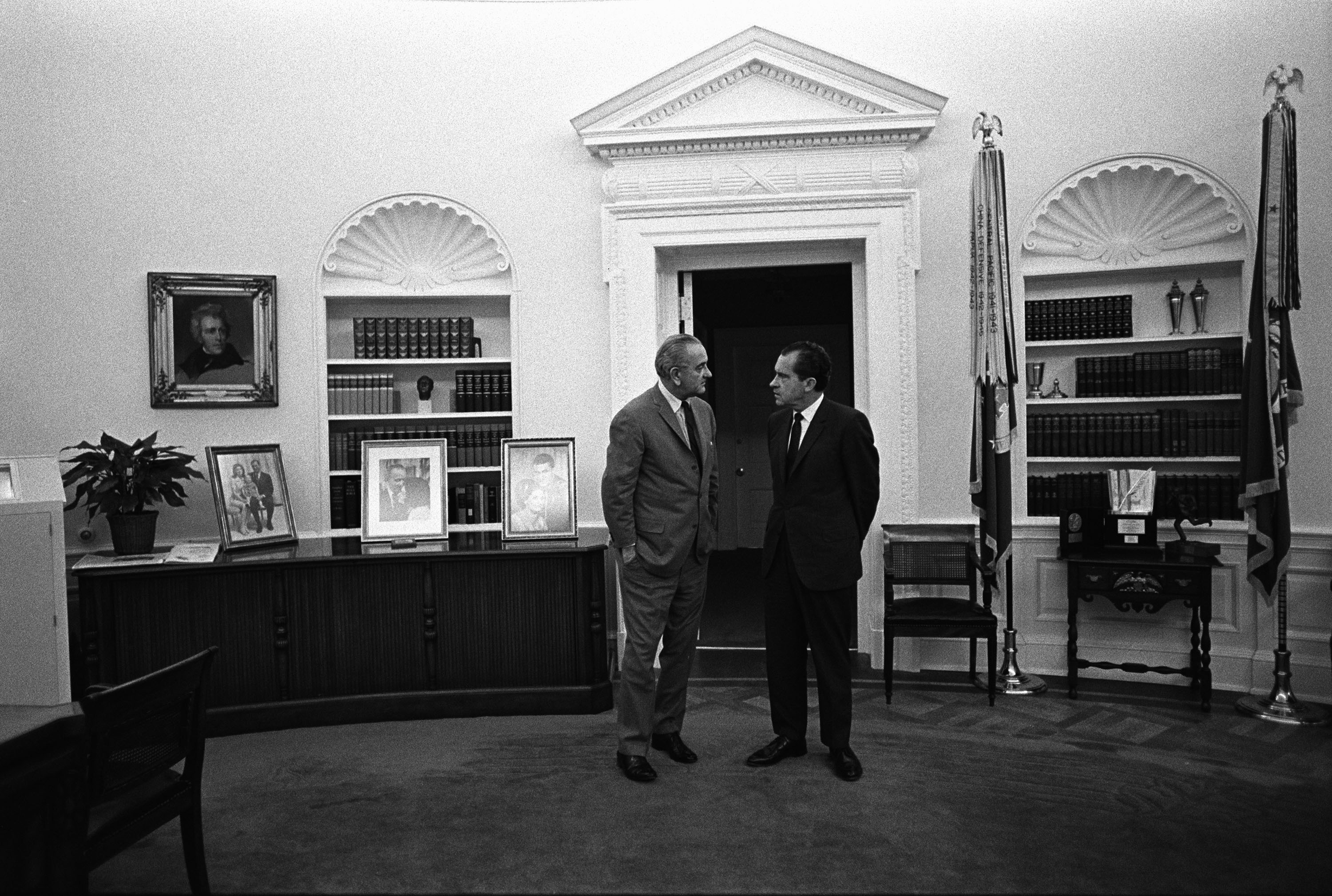 President Johnson, left, leans over president-elect Richard Nixon in the Oval Office.